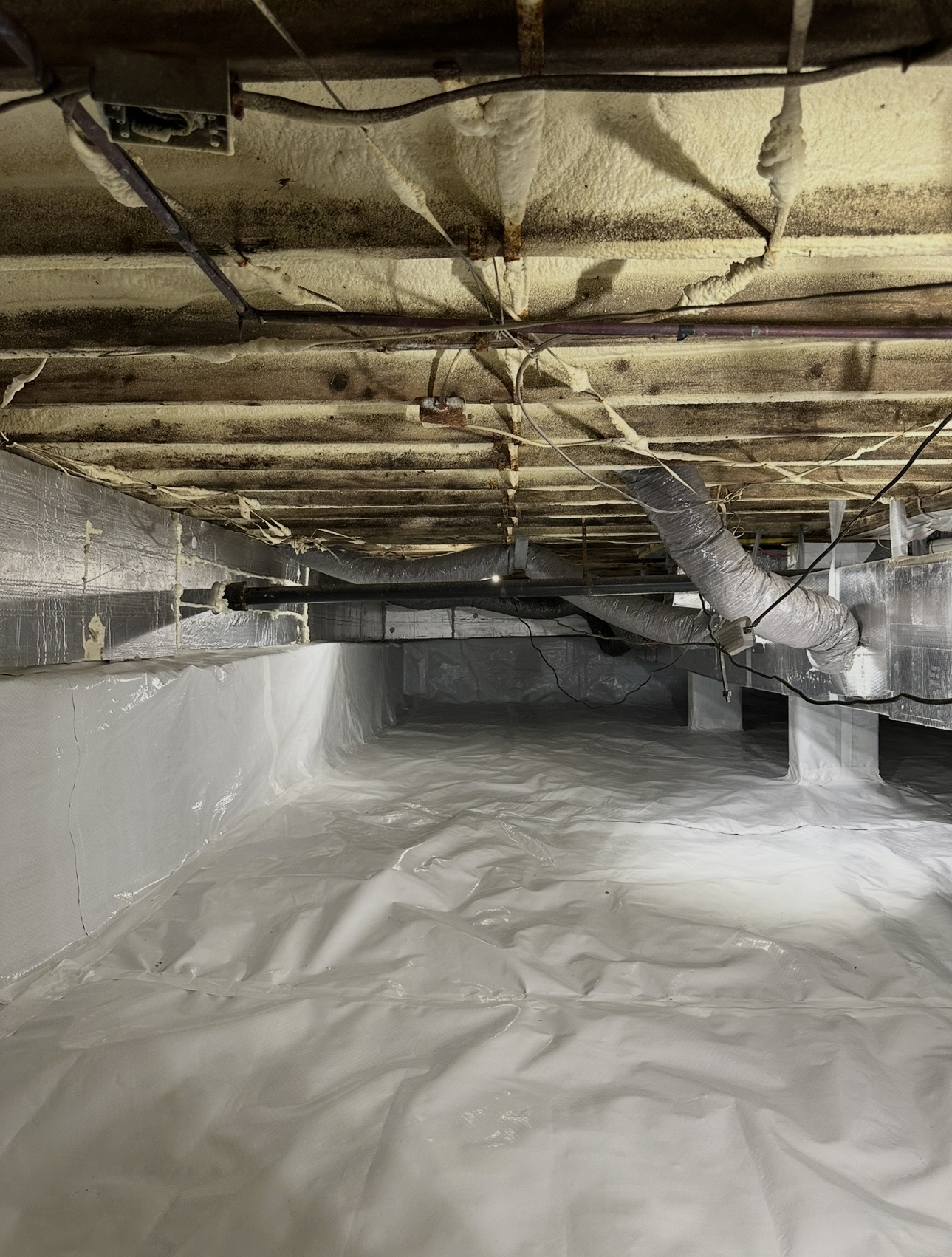 After: Torn, Debris-Filled Crawlspace → Sealed Vapor Barrier System
